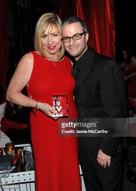Kathy Kastan holds the Red Dress award created by Steuben Glass with Steuben Glass Vice President of Product Design Robert Nachman at the 7th Annual...