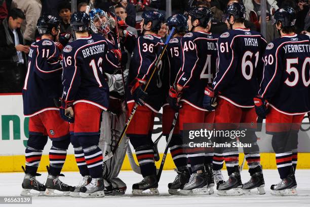 Goaltender Steve Mason of the Columbus Blue Jackets is congratulated by his teammates after he stopped 40 shots in a 3-0 shutout over the San Jose...