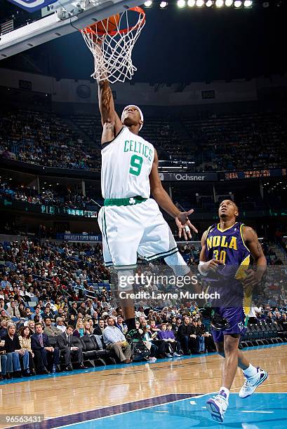 Rajon Rondo of the Boston Celtics dunks on David West of the New Orleans Hornets on February 10, 2010 at the New Orleans Arena in New Orleans,...