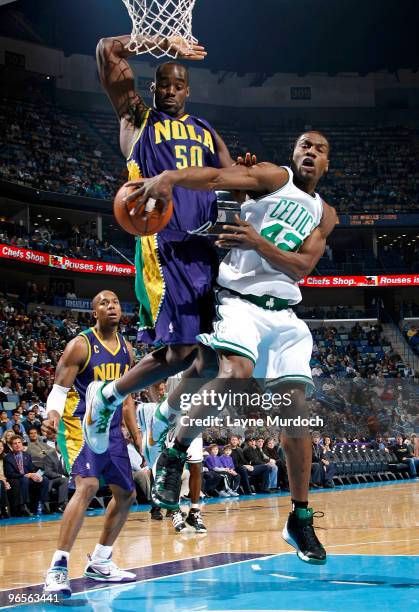 Tony Allen of the Boston Celtics attempts to pass the ball around Emeka Okafor and David West of the New Orleans Hornets on February 10, 2010 at the...
