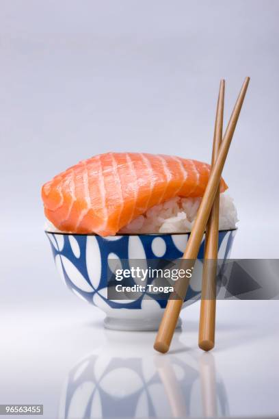 bowl of sushi rice and piece of raw salmon - fatty acid stock pictures, royalty-free photos & images