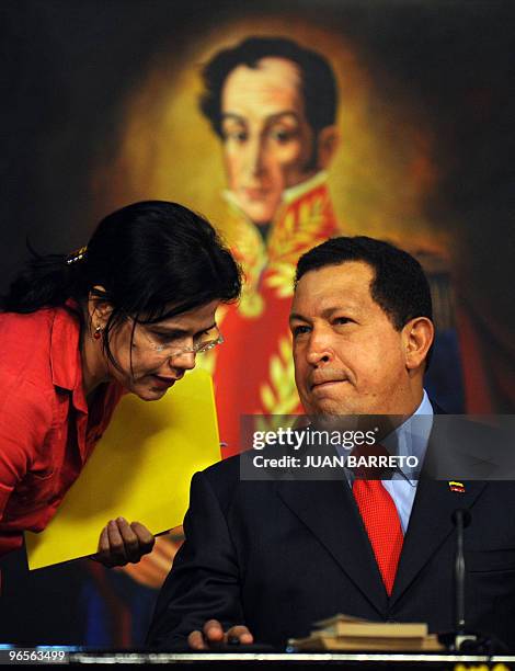 Venezuelan President Hugo Chavez confers with Venezuelan Information Minister Blanca Eckhout during an event in which permission was granted for...