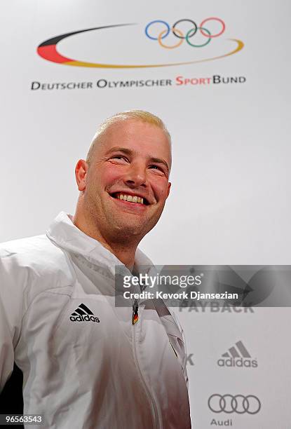 André Lange reacts after a news conference to announce he is the flag bearer of the German Olympic team ahead of the Vancouver 2010 Winter Olympics...