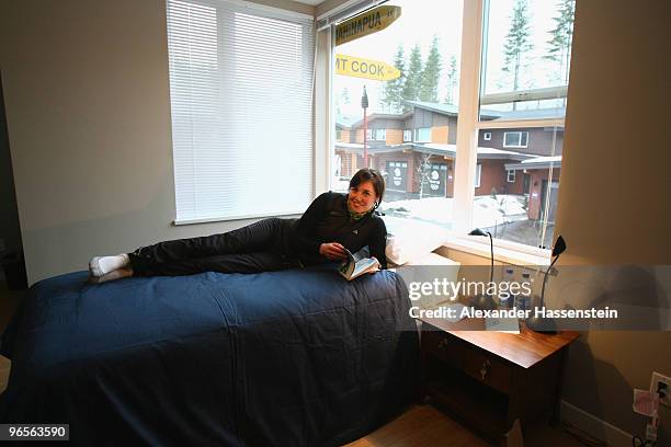 Biathlon athlete Sarah Murphy of New Zealand poses on her bed at her suite at the Whistler Olympic village during the media tour ahead of the...