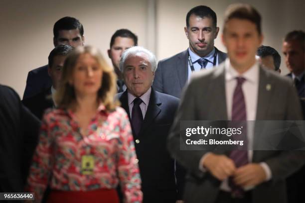 Michel Temer, Brazil's president, center, leaves after speaking at a press conference on the resignation of Petroleos Brasileiros SA chief executive...