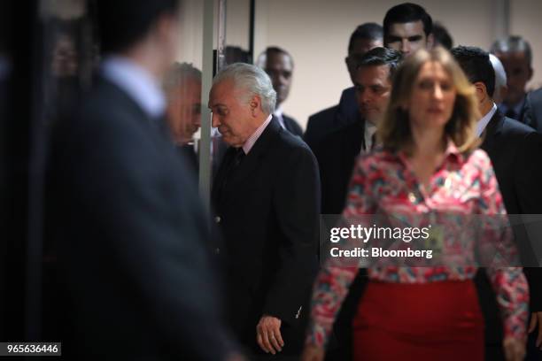 Michel Temer, Brazil's president, center, leaves after speaking at a press conference on the resignation of Petroleos Brasileiros SA chief executive...