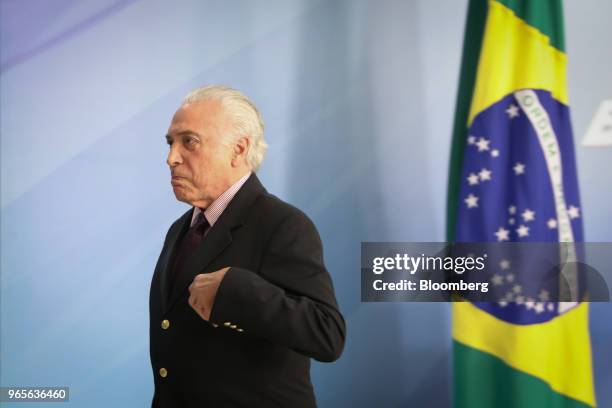 Michel Temer, Brazil's president, leaves after speaking at a press conference on the resignation of Petroleos Brasileiros SA chief executive officer...