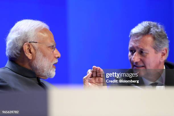 Narendra Modi, India's prime minister, left, speaks with John Chipman, chief executive of the IISS , before delivering the keynote address during the...