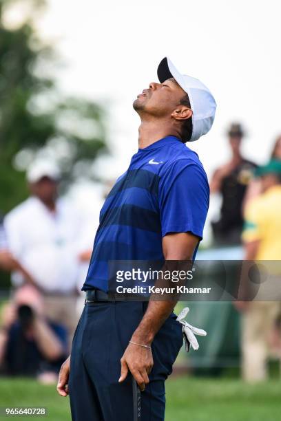 Tiger Woods reacts to missing his putt on the 18th hole green during the second round of the Memorial Tournament presented by Nationwide at Muirfield...