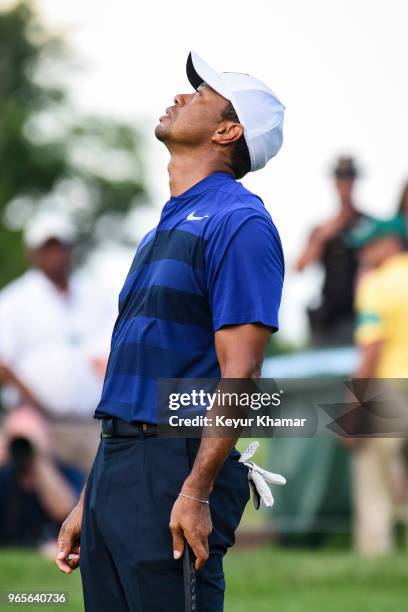 Tiger Woods reacts to missing his putt on the 18th hole green during the second round of the Memorial Tournament presented by Nationwide at Muirfield...