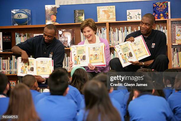 Jason Terry of the Dallas Mavericks, Former first lady Laura Bush and former NBA player Dikembe Mutombo reads to kids during the NBA Cares All-Star...