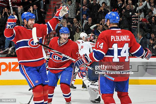 Roman Hamrlik of Montreal Canadiens celebrates with teammate Sergei Kostitsyn the victory goal of Tomas Plekanec during the NHL game against the...