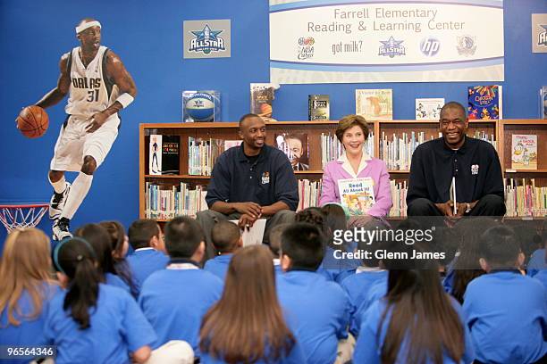 Jason Terry of the Dallas Mavericks, Former first lady Laura Bush and former NBA player Dikembe Mutombo reads during the NBA Cares All-Star 2010...
