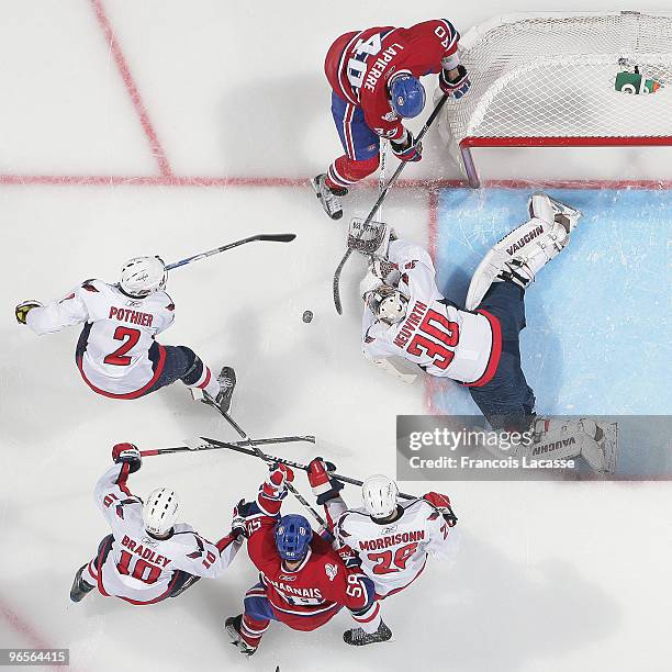 Michal Neuvirth of the Washington Capitals blocks a shot of Maxim Lapierre of Montreal Canadiens during the NHL game on February 10, 2010 at the Bell...