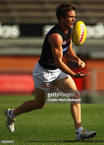 Travis Colyer of the Bombers handballs during an Essendon Bombers training session at Windy Hill on February 11, 2010 in Melbourne, Australia. Colyer...