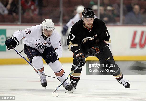 Petteri Nokelainen of the Anaheim Ducks is pursued by Andrew Cogliano of the Edmonton Oilers for the puck in the first period at the Honda Center on...