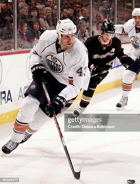 Jason Strudwick of the Edmonton Oilers moves the puck against the Anaheim Ducks during the game on February 10, 2010 at Honda Center in Anaheim,...