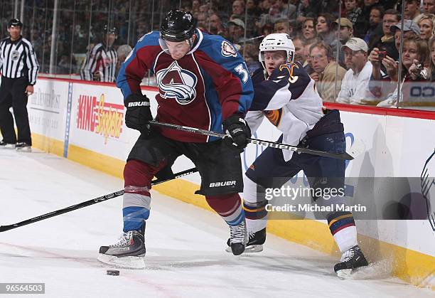 Galiardi of the Colorado Avalanche kicks the puck away from Tobias Enstrom of the Atlanta Thrashers at the Pepsi Center on February 10, 2010 in...