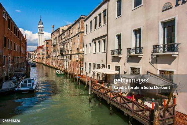 canal among houses in venice, italy - brillant foto e immagini stock