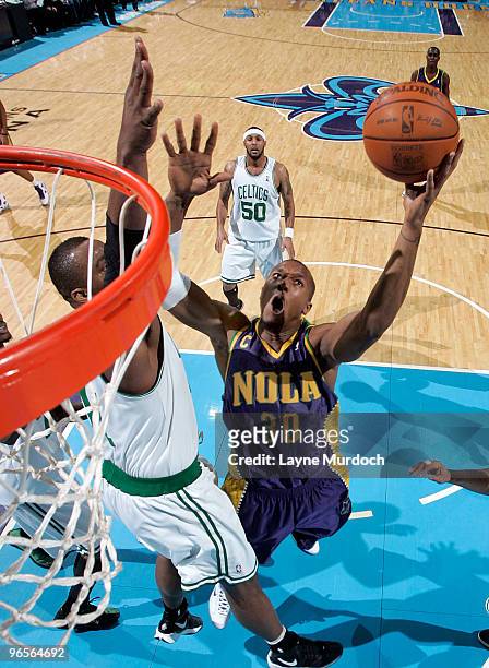 David West of the New Orleans Hornets shoots over Glen Davis of the Boston Celtics on February 10, 2010 at the New Orleans Arena in New Orleans,...