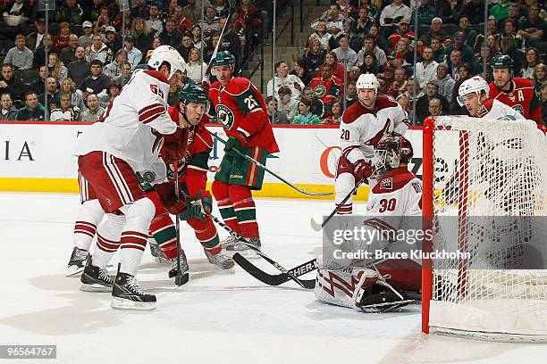 Goalie Ilya Bryzgalov and his Phoenix Coyotes teammate Ed Jovanovski defend against Andrew Brunette of the Minnesota Wild during the game at the Xcel...