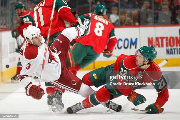 Cal Clutterbuck of the Minnesota Wild and Keith Yandle of the Phoenix Coyotes collide during the game at the Xcel Energy Center on February 10, 2010...