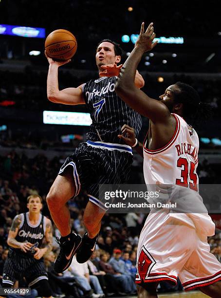 Redick of the Orlando Magic puts up a shot against Chris Richard of the Chicago Bulls at the United Center on February 10, 2010 in Chicago, Illinois....