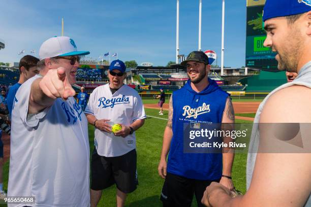 Eric Stonestreet talks with the Kansas City Royals players while taking part in the celebrity softball game at Kauffman Stadium during the Big Slick...