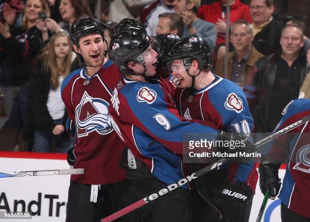 Kyle Quincey and Matt Duchene of the Colorado Avalanche congratulate Kyle Cumiskey after the game winning goal against the Atlanta Thrashers at the...