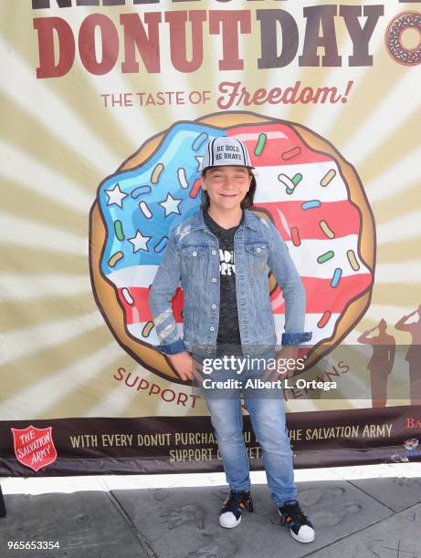 Actor Bryson Robinson participates in The Salvation Army And Bakemark's 2nd Annual National Donut Day World Donut Eating Championship To Benefit...