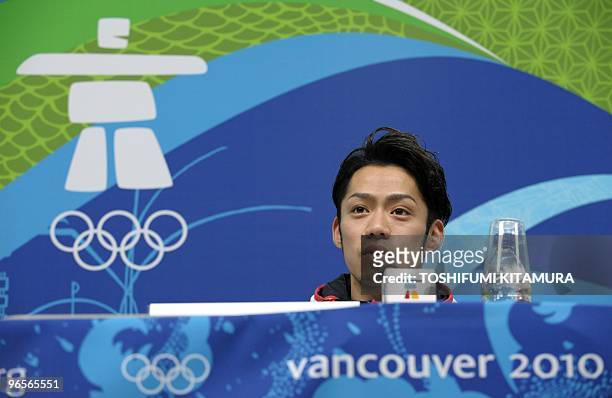 Japanese men's singles figure skater Daisuke Takahashi answers a question during the Japanese men's figure skating team press conference at the...
