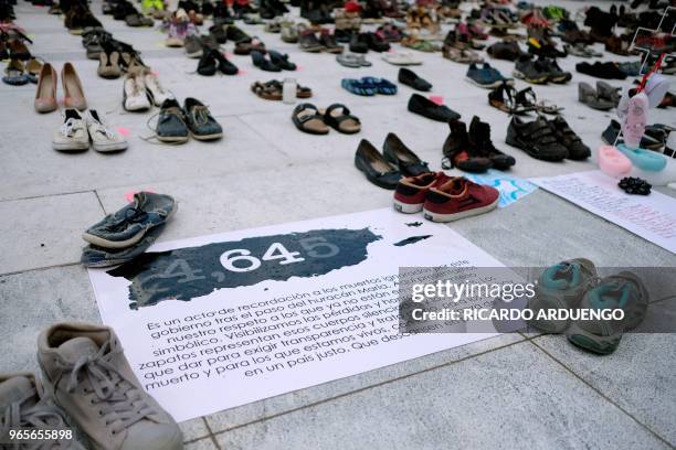 View of displayed shoes in memory of those killed by Hurricane Maria in front of the Puerto Rican Capitol, in San Juan, on June 1, 2018. - Hurricane...