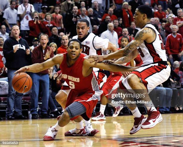 Chace Stanback and Tre'Von Willis of the UNLV Rebels try to trap Dairese Gary of the New Mexico Lobos in the backcourt during their game at the...