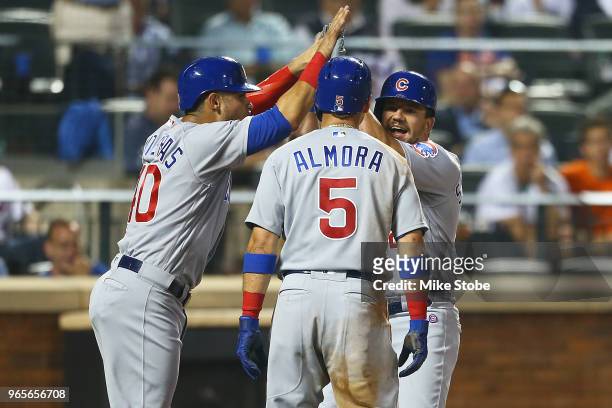 Kyle Schwarber of the Chicago Cubs celebrates with Albert Almora Jr. #5 and Willson Contreras after hitting a three-run home run in the top of the...