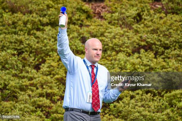 Rules Official Ken Tackett blows the horn to signal resumption of play after a rain delay on the 12th hole during the second round of the Memorial...