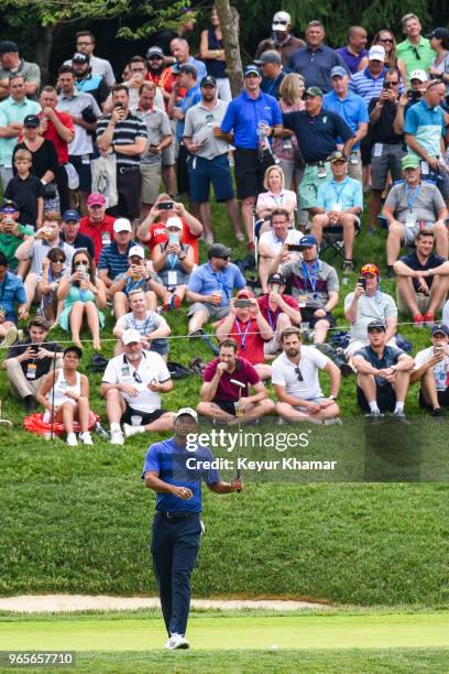 Tiger Woods reacts to missing his birdie putt on the 12th hole green as fans watch during the second round of the Memorial Tournament presented by...