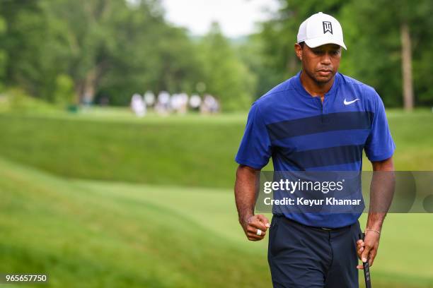 Tiger Woods celebrates and pumps his fist after making a birdie putt on the 15th hole green during the second round of the Memorial Tournament...