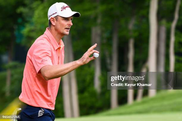 Justin Rose of England waves his ball to fans after making a birdie putt on the 15th hole green during the second round of the Memorial Tournament...