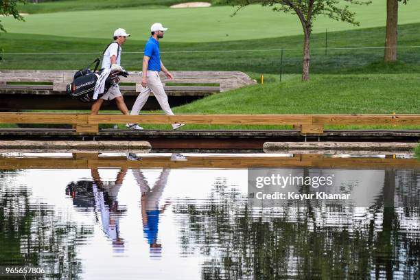 Kyle Stanley and his caddie cross the bridge to the ninth hole green during the second round of the Memorial Tournament presented by Nationwide at...