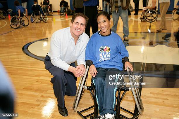 Dallas Mavericks owner Mark Cuban poses for a portrait with a young girl during the NBA/NWBA All-Star Wheelchair Classic Basketbal Clinic as part of...