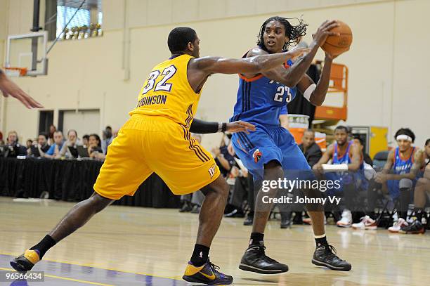 Larry Owens of the Tulsa 66ers against holds the ball against Frank Robinson of the Los Angeles D-Fenders at Toyota Sports Center on February 10,...