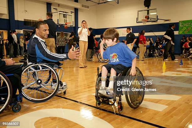 Two players high-five each other during the NBA/NWBA All-Star Wheelchair Classic Basketbal Clinic as part of the 2010 NBA All-Star Weekend on...