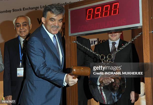 President of Turkey Abdullah Gul sounds the gong to start the day's trading at the Bombay Stock Exchange during a visit in Mumbai on February 11,...