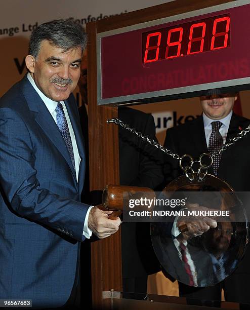 President of Turkey Abdullah Gul sounds the gong to start the day's trading at the Bombay Stock Exchange during a visit in Mumbai on February 11,...
