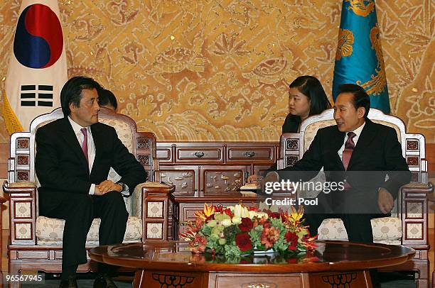 Japanese Foreign Minister Katsuya Okada talks hands with South Korean President Lee Myung-Bak at the presidential house on February 11, 2010 in...