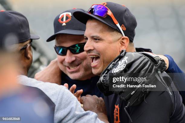 Bench coach Derek Shelton of the Minnesota Twins jokes with Victor Martinez of the Detroit Tigers during batting practice before the game on May 22,...