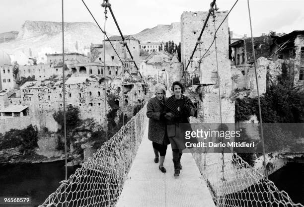 Two women crossing a temporary bridge at the site the Old Bridge in Mostar, former Yugoslavia, on November 8, 1995. The original bridge was destroyed...