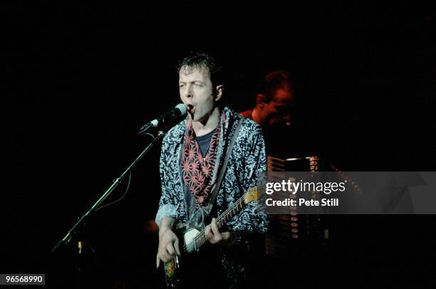 Joe Strummer performs on stage with The Pogues at Brixton Academy on December 11th, 1991 in London, United Kingdom.