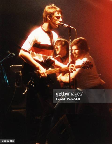 Paul Weller of The Jam performs at Wembley Arena while a member of the audience is escorted off the stage by security personel, on December 3rd, 1982...