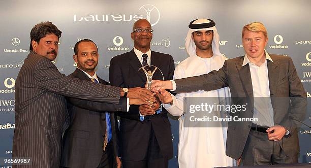 Edwin Moses of the USA The Chairman of the Laureus World Sports Academy with His Excellency Mohammed Ibrahim Al Mahmood The Secretary General of the...